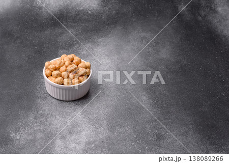Whole peeled hazelnuts, roasted or raw, as an ingredient for healthy food. Hazelnuts as a background 138089266