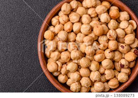 Whole peeled hazelnuts, roasted or raw, as an ingredient for healthy food. Hazelnuts as a background 138089273
