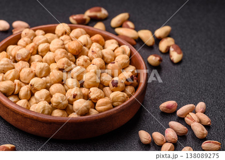 Whole peeled hazelnuts, roasted or raw, as an ingredient for healthy food. Hazelnuts as a background 138089275
