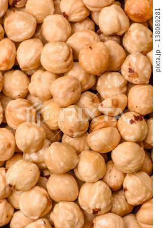 Whole peeled hazelnuts, roasted or raw, as an ingredient for healthy food. Hazelnuts as a background 138089281
