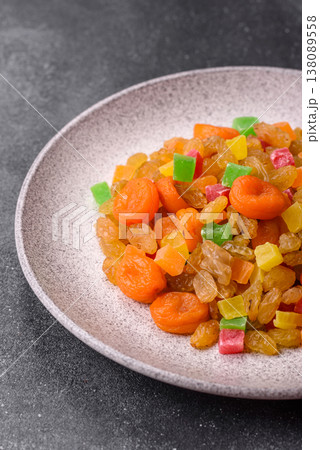 Dried apricots, raisins, and candied fruits as ingredients for baked goods and sweets. Dried fruits Dried apricots, raisins, and candied fruits as ingredients for baked goods and sweets. Dried fruits 138089558