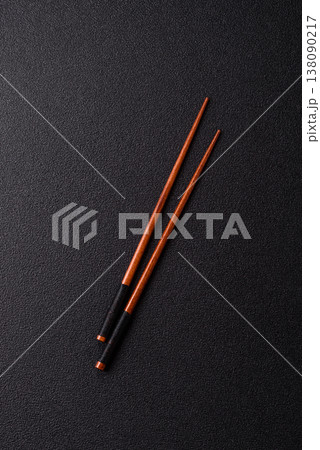 Wooden bamboo chopsticks for sushi and other Asian food with a blank background. Wooden chopsticks 138090217