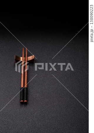 Wooden bamboo chopsticks for sushi and other Asian food with a blank background. Wooden chopsticks 138090223
