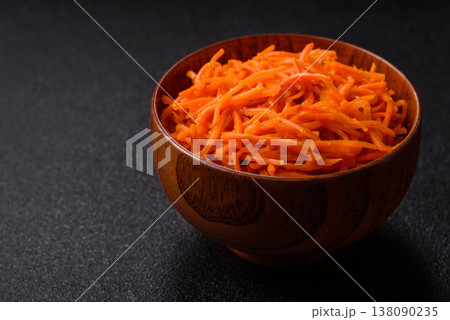 Spicy Korean carrot salad, grated with salt and spices, an Asian dish. Korean carrots Spicy Korean carrot salad, grated with salt and spices, an Asian dish. Korean carrots 138090235