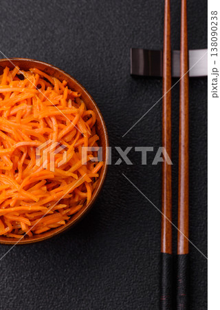 Spicy Korean carrot salad, grated with salt and spices, an Asian dish. Korean carrots Spicy Korean carrot salad, grated with salt and spices, an Asian dish. Korean carrots 138090238