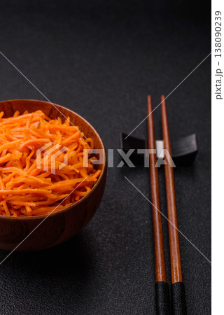 Spicy Korean carrot salad, grated with salt and spices, an Asian dish. Korean carrots Spicy Korean carrot salad, grated with salt and spices, an Asian dish. Korean carrots 138090239