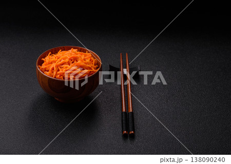 Spicy Korean carrot salad, grated with salt and spices, an Asian dish. Korean carrots Spicy Korean carrot salad, grated with salt and spices, an Asian dish. Korean carrots 138090240