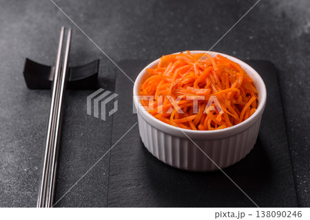 Spicy Korean carrot salad, grated with salt and spices, an Asian dish. Korean carrots 138090246