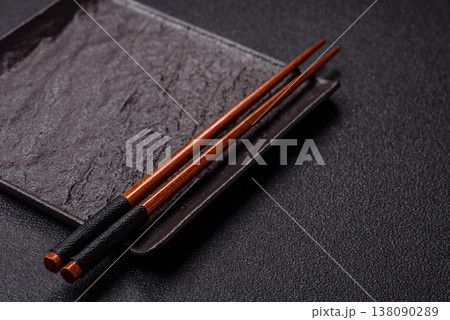 An empty ceramic square black plate with chopsticks for Asian food. An empty square plate 138090289