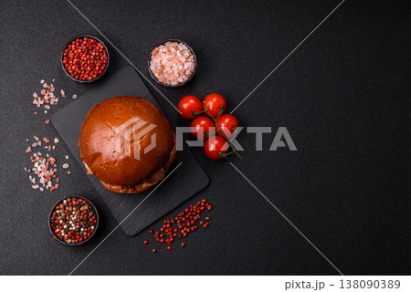 A burger with a patty, cheese, vegetables, and sauce. A burger with meat 138090389