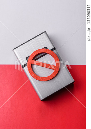 A metal cigarette box with a no smoking sign depicts a harmful habit. A cigarette box 138090512