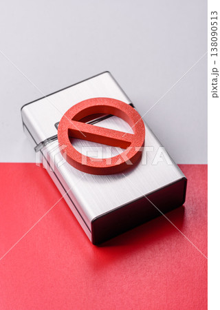A metal cigarette box with a no smoking sign depicts a harmful habit. A cigarette box 138090513