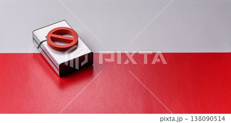 A metal cigarette box with a no smoking sign depicts a harmful habit. A cigarette box 138090514