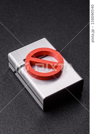A metal cigarette box with a no smoking sign depicts a harmful habit. A cigarette box A metal cigarette box with a no smoking sign depicts a harmful habit. A cigarette box 138090540