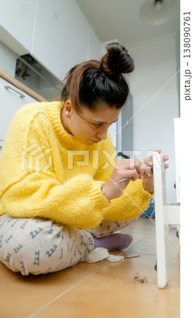 Closeup Of Woman Attaching Drawer. Focused Image Of Woman Securing Drawer Within Cabinet Frame Closeup Of Woman Attaching Drawer. Focused Image Of Woman Securing Drawer Within Cabinet Frame 138090761