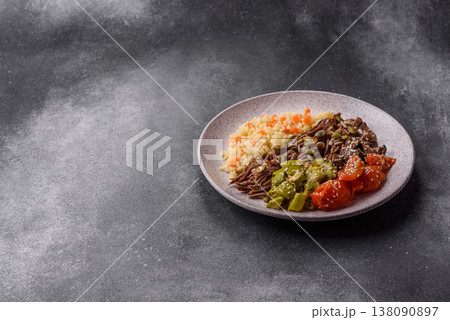 A bowl with beef, porridge, mushrooms, vegetables, sauce, and spices. Beef bowl 138090897