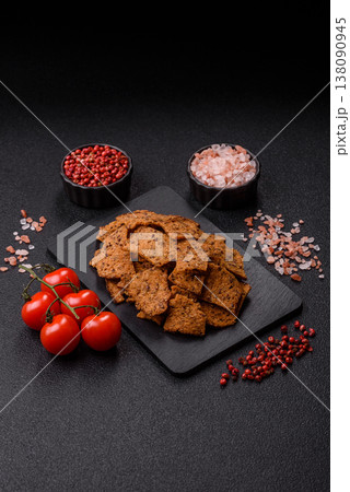 Croutons or crackers made from rye bread with garlic, salt, and spices. Croutons with salt Croutons or crackers made from rye bread with garlic, salt, and spices. Croutons with salt 138090945