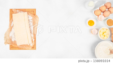 Puff pastry dough and baking ingredients on white background, top view preparation composition with copy space 138091014