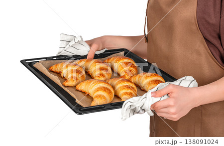 Baker holding tray with baked croissants isolated on white background, homemade pastry presentation Baker holding tray with baked croissants isolated on white background, homemade pastry presentation 138091024