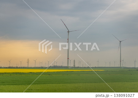 Wind turbines over green farmland at sunset Wind turbines over green farmland at sunset 138091027
