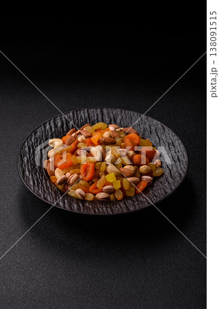 A mix of nuts and dried fruits as ingredients for a healthy meal. Nuts and dried fruits A mix of nuts and dried fruits as ingredients for a healthy meal. Nuts and dried fruits 138091515