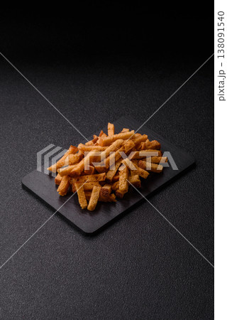 Croutons or crackers made from rye bread with garlic, salt, and spices. Croutons with salt Croutons or crackers made from rye bread with garlic, salt, and spices. Croutons with salt 138091540