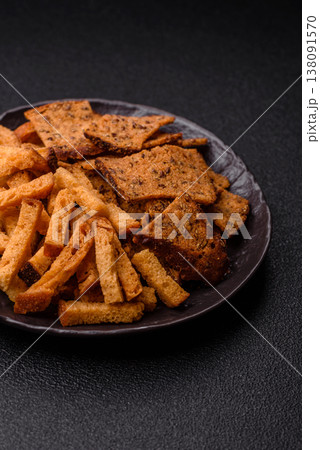 Croutons or crackers made from rye bread with garlic, salt, and spices. Croutons with salt Croutons or crackers made from rye bread with garlic, salt, and spices. Croutons with salt 138091570