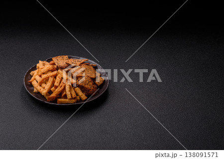 Croutons or crackers made from rye bread with garlic, salt, and spices. Croutons with salt Croutons or crackers made from rye bread with garlic, salt, and spices. Croutons with salt 138091571