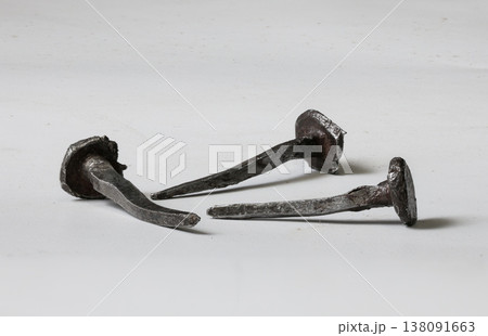 Unique old iron nails crafted by hand showcasing artisan skill in metalwork from a historical period 138091663