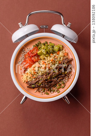 A bowl with beef, porridge, mushrooms, vegetables, sauce, and spices. Beef bowl 138092186