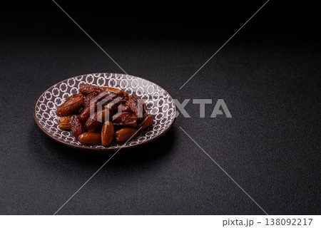 Dried dates on a ceramic plate for Ramadan or Iftar. Dates fruit as a background Dried dates on a ceramic plate for Ramadan or Iftar. Dates fruit as a background 138092217