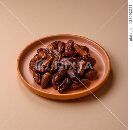 Dried dates on a ceramic plate for Ramadan or Iftar. Dates fruit as a background Dried dates on a ceramic plate for Ramadan or Iftar. Dates fruit as a background 138092221