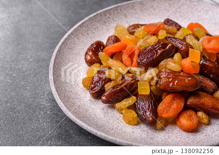 Dried apricots, raisins, and candied fruits as ingredients for baked goods and sweets. Dried fruits Dried apricots, raisins, and candied fruits as ingredients for baked goods and sweets. Dried fruits 138092256