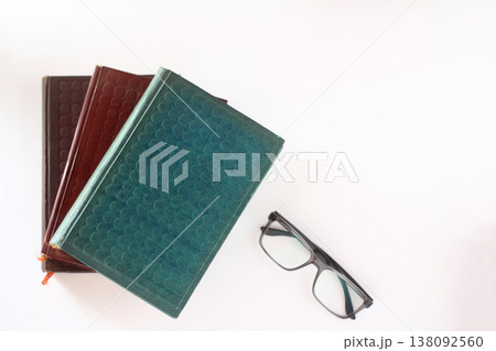 pile of books and glasses isolated on white background pile of books and glasses isolated on white background 138092560