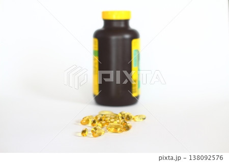 Omega 3 yellow capsules and pill bottle on white background Omega 3 yellow capsules and pill bottle on white background 138092576