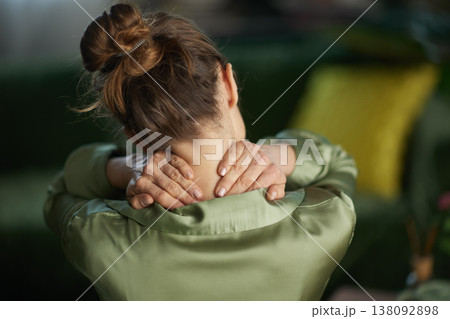Woman Crossing Arms to Massage Her Sore Neck and Shoulders Woman Crossing Arms to Massage Her Sore Neck and Shoulders 138092898