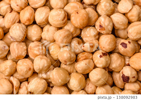 Whole peeled hazelnuts, roasted or raw, as an ingredient for healthy food. Hazelnuts as a background 138092983