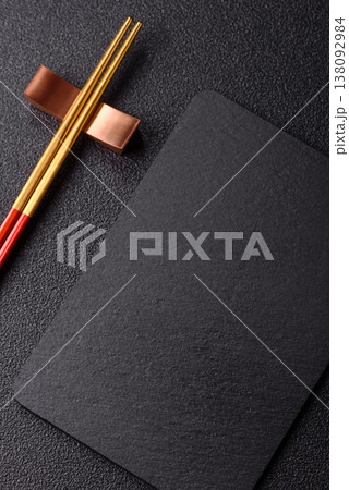 An empty slate cutting board with cutlery on a kitchen counter. Slate cutting board 138092984