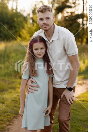 Confident Father In Casual Attire Sharing Proud Moment With His Daughter In Open Field 138093016