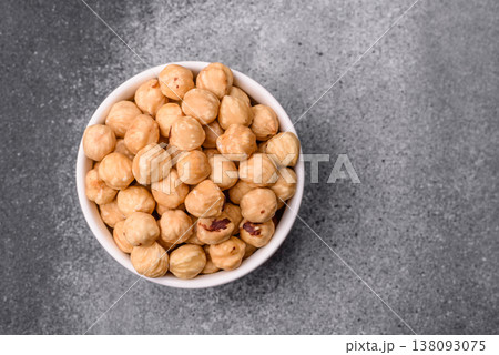 Whole peeled hazelnuts, roasted or raw, as an ingredient for healthy food. Hazelnuts as a background 138093075