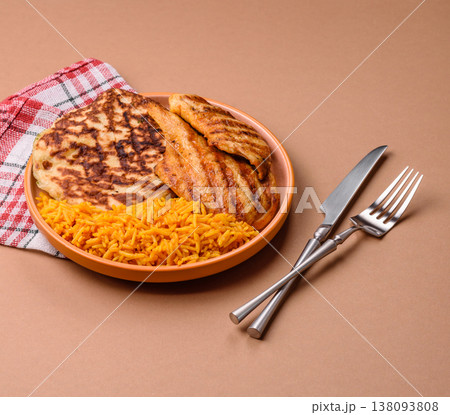 Dajaj Mashwi, an Arabic dish with rice and chicken, salt, and spices. Dajaj Mashwi as a background Dajaj Mashwi, an Arabic dish with rice and chicken, salt, and spices. Dajaj Mashwi as a background 138093808