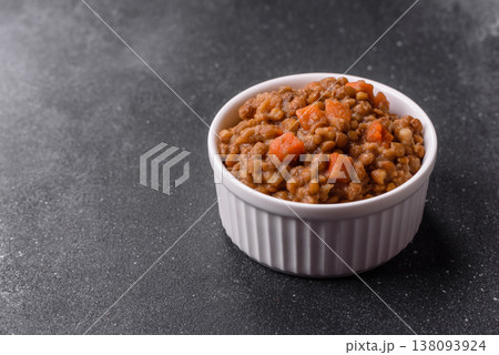 Lentil, carrot, and tomato stew with sausages, a European dish. Lentils with sausages 138093924