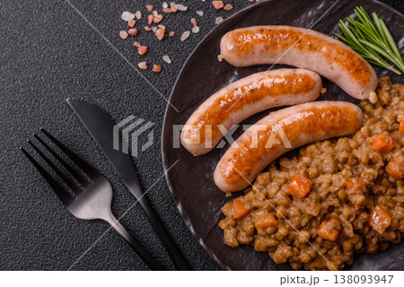 Lentil, carrot, and tomato stew with sausages, a European dish. Lentils with sausages 138093947