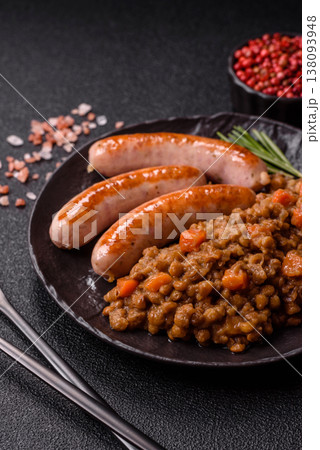 Lentil, carrot, and tomato stew with sausages, a European dish. Lentils with sausages 138093948
