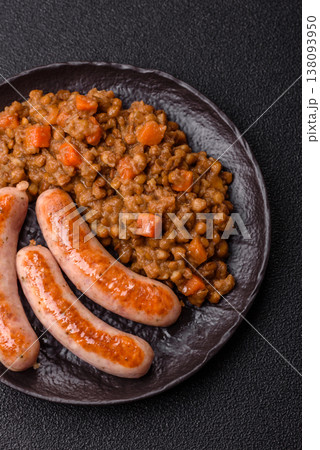 Lentil, carrot, and tomato stew with sausages, a European dish. Lentils with sausages 138093950