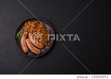 Lentil, carrot, and tomato stew with sausages, a European dish. Lentils with sausages 138093953