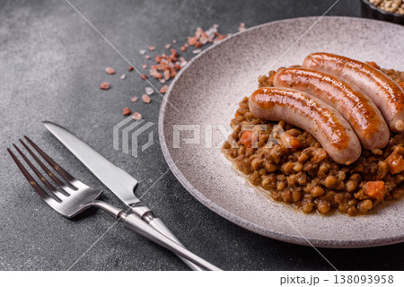 Lentil, carrot, and tomato stew with sausages, a European dish. Lentils with sausages 138093958