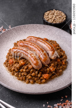 Lentil, carrot, and tomato stew with sausages, a European dish. Lentils with sausages 138093960
