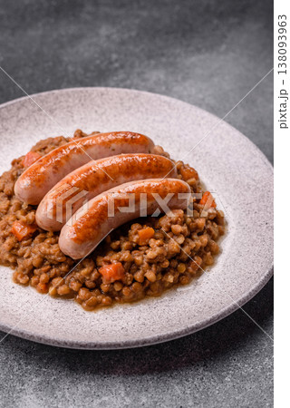 Lentil, carrot, and tomato stew with sausages, a European dish. Lentils with sausages 138093963