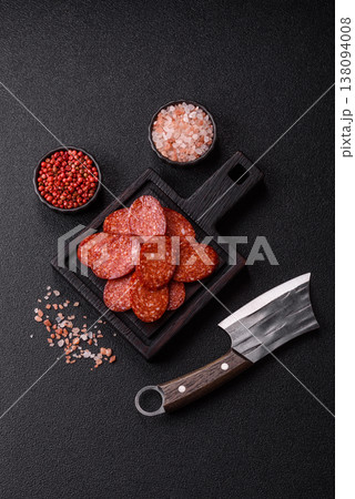Sliced smoked pepperoni or salami as a pizza topping. Pepperoni sausage 138094008